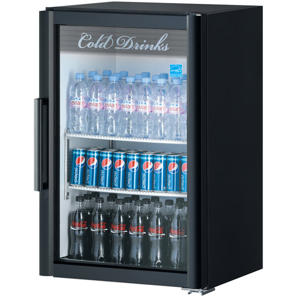 A Turbo Air black countertop display refrigerator with bottles of soda and cans inside.