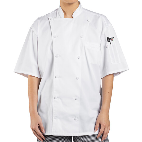 A woman wearing a white Uncommon Chef Aruba Pro chef coat.