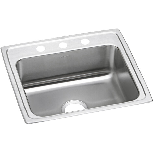 An Elkay stainless steel sink with three faucet holes on a counter.