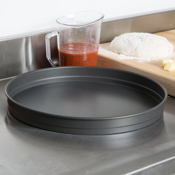 An American Metalcraft hard coat anodized aluminum round cake pan on a counter.