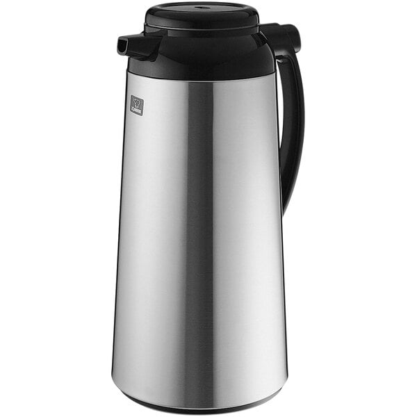 A Zojirushi stainless steel coffee carafe with a black push button stopper.