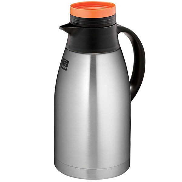 A Zojirushi stainless steel coffee carafe with an orange lid.
