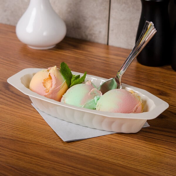 A Fineline Flairware ivory plastic oval bowl filled with two scoops of ice cream, one pink and one yellow.