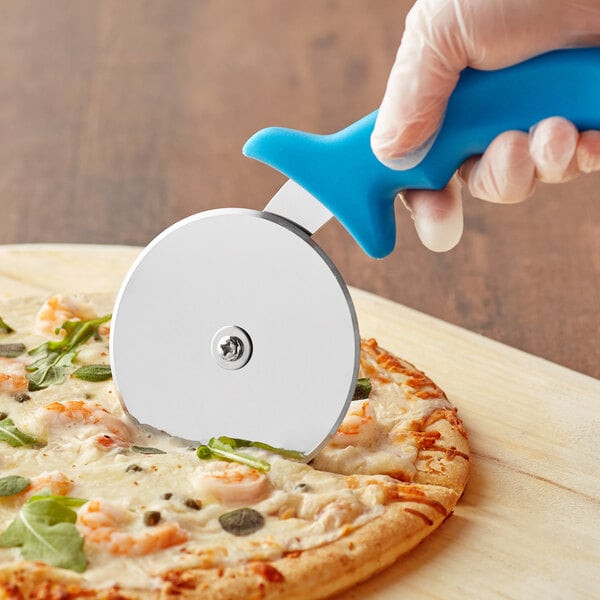 A person using a Choice pizza cutter with a blue handle to cut a pizza.