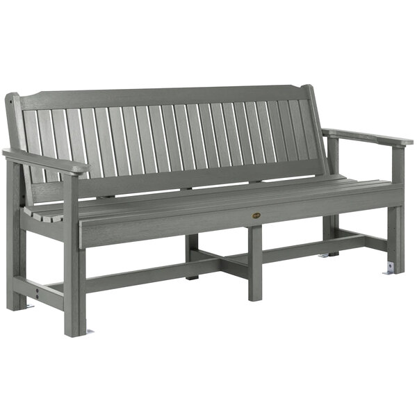 A Coastal Teak faux wood bench with gray armrests.