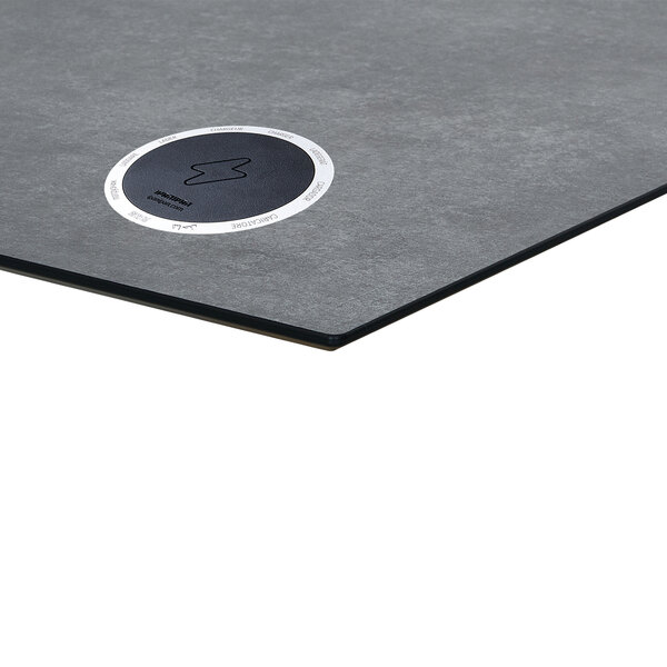A grey rectangular BFM table top with a black circle with a white circle in it.