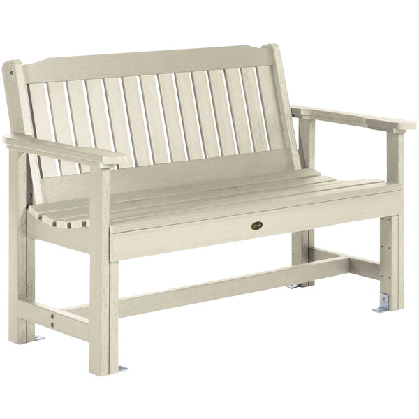 A whitewash faux wood outdoor bench with arms.