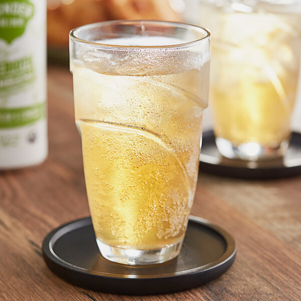 A close-up of a Wonder Drink Organic Asian Pear and Ginger Kombucha in a glass.