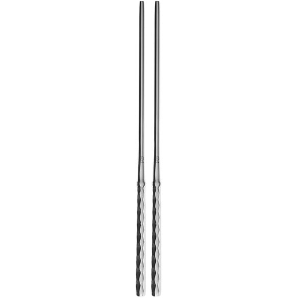 Two Sola stainless steel chopsticks with a diamond pattern.