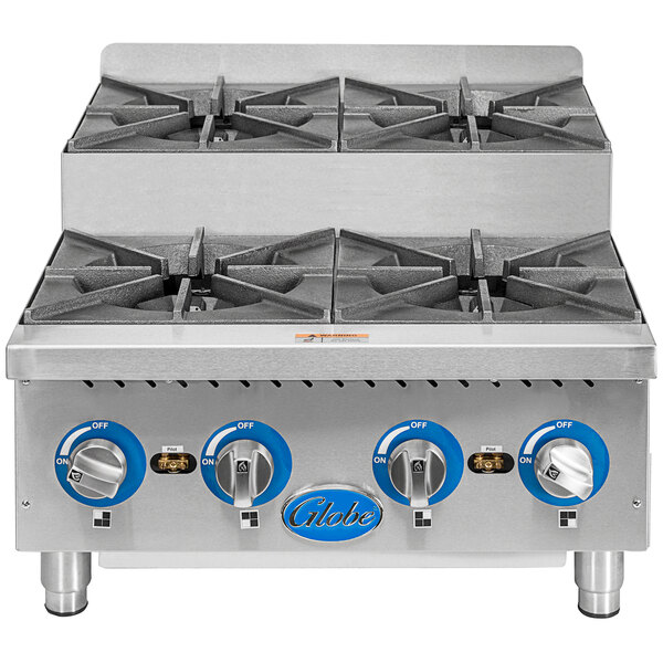 A Globe countertop gas range with four step-up burners on a counter.