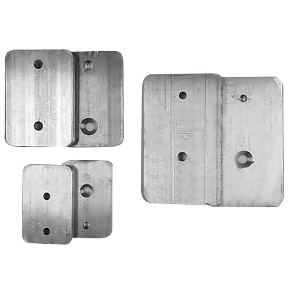 A group of four metal plates with holes.