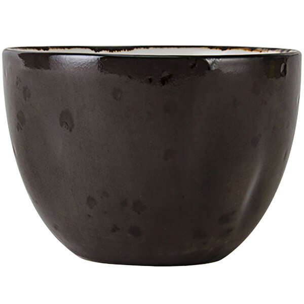 A black bouillon cup with a white rim.