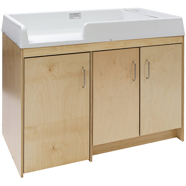 A natural birch plywood Tot Mate toddler changing table with two drawers.