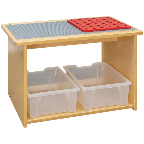 A Tot Mate maple laminate preschool play center with two plastic bins.