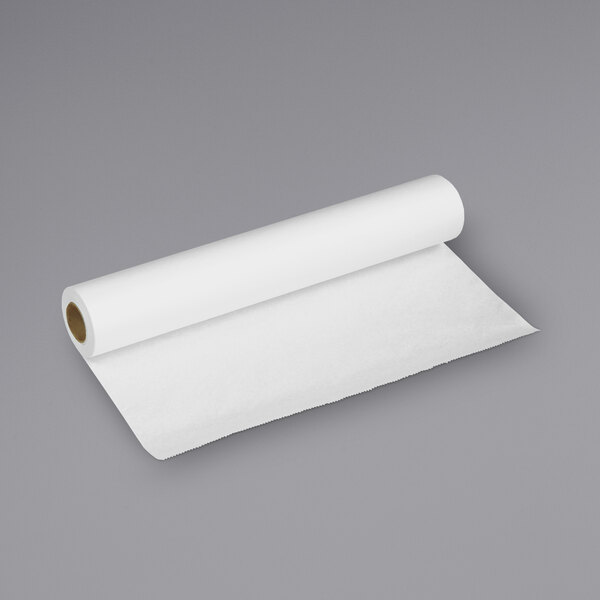 A Tot Mate changing table paper roll on a gray surface.
