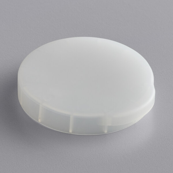 An American Metalcraft white plastic lid on a gray surface.