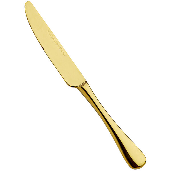 A Bon Chef Como stainless steel dinner knife with a gold solid handle.