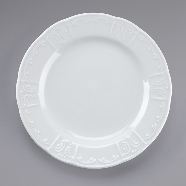 A close-up of a Tuxton Chicago bright white china plate with a pattern on it.