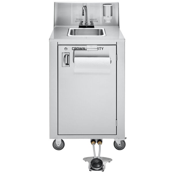 A Crown Verity mobile stainless steel handwashing station with a paper towel dispenser above the sink.