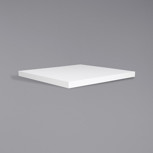 A white square BFM Seating tabletop on a gray surface.