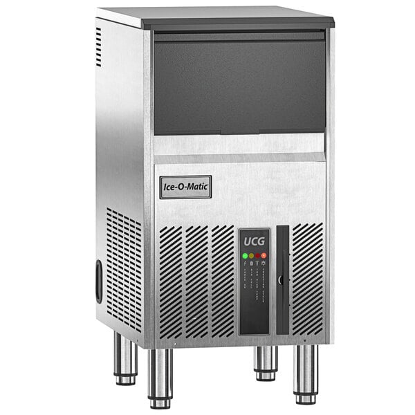 An Ice-O-Matic undercounter ice machine on a stainless steel counter.