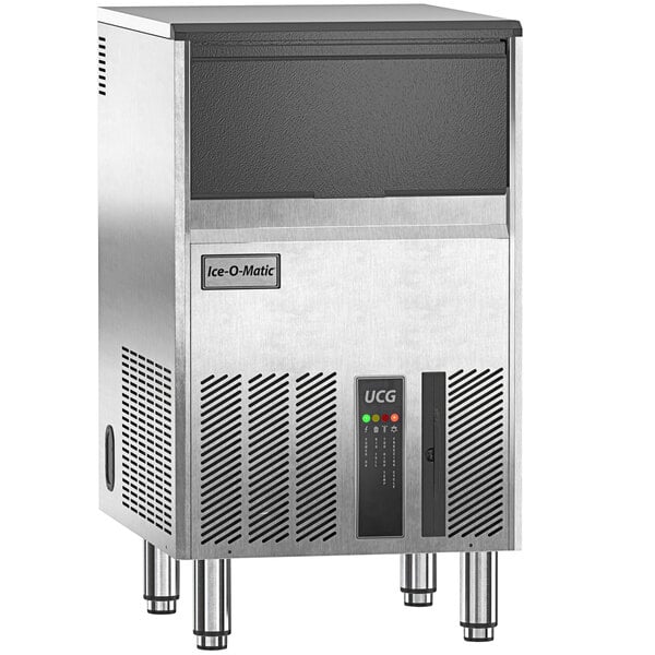 An Ice-O-Matic undercounter ice machine with a stainless steel and black exterior.