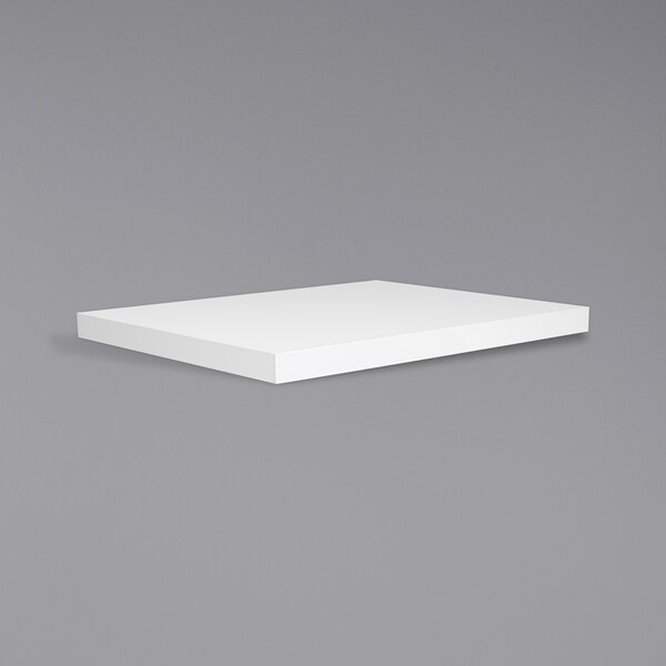A white rectangular tabletop on a gray surface.