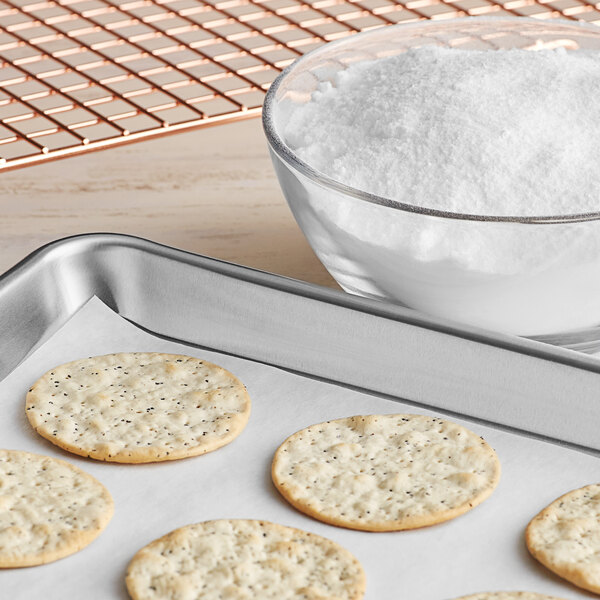 A group of round white crackers on a baking sheet.