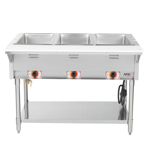An APW Wyott stainless steel stationary steam table with three sealed wells on a counter.