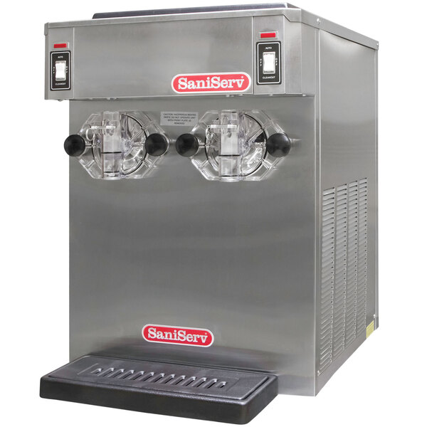 A SaniServ commercial ice cream machine on a white background with two clear containers.