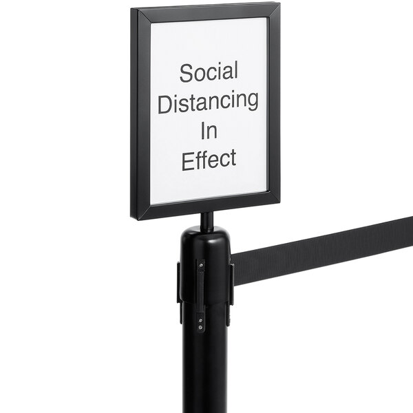 An American Metalcraft black sign that reads "Social Distancing In Effect" attached to a black ribbon.