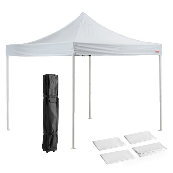 A white tent with a black bag and a white cover.