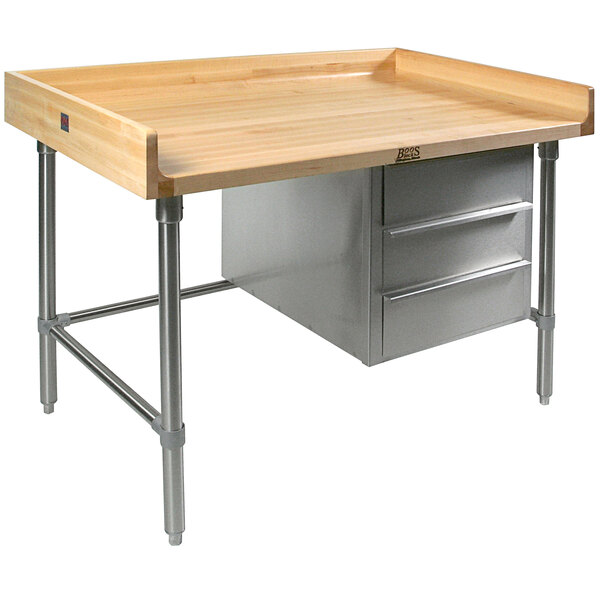 A John Boos wood top work table with stainless steel base and two drawers.