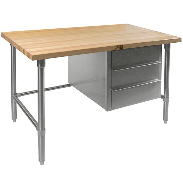 A John Boos wood top work table with stainless steel base and two drawers.