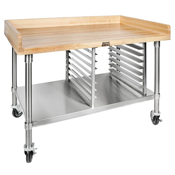 A John Boos wood top baker's table with stainless steel shelves on wheels.