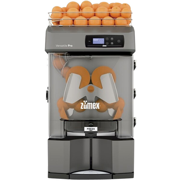 A Zumex Versatile Pro automatic feed juicer with oranges inside.