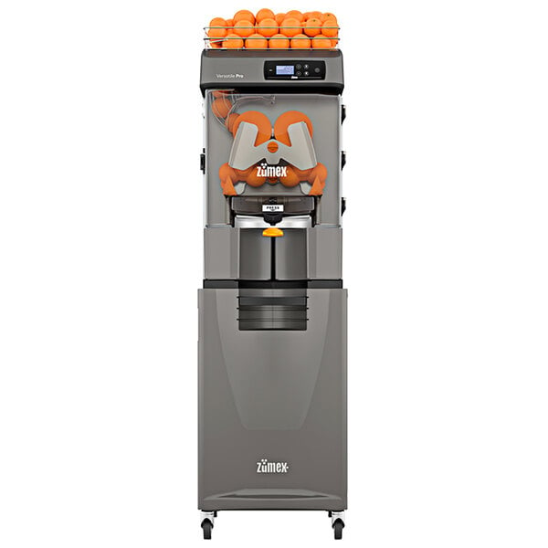 A Zumex Versatile Pro juicer with oranges on top.