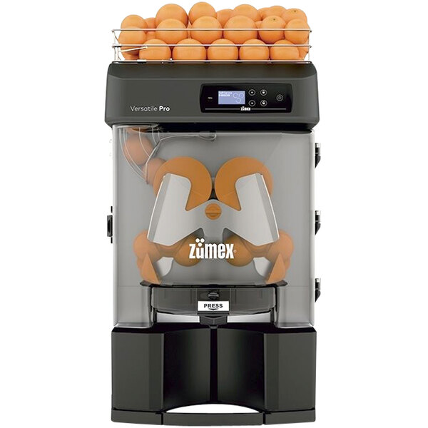 A Zumex Versatile Pro juicer with oranges on top.