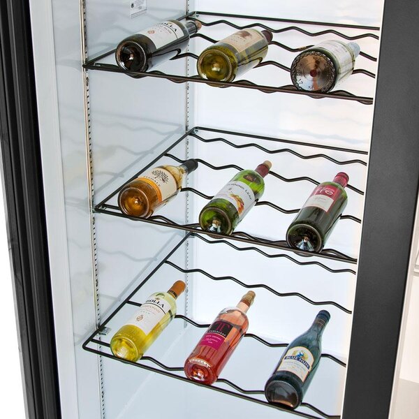 A Beverage-Air wine rack filled with white wine bottles on shelves in a refrigerator with a glass door.