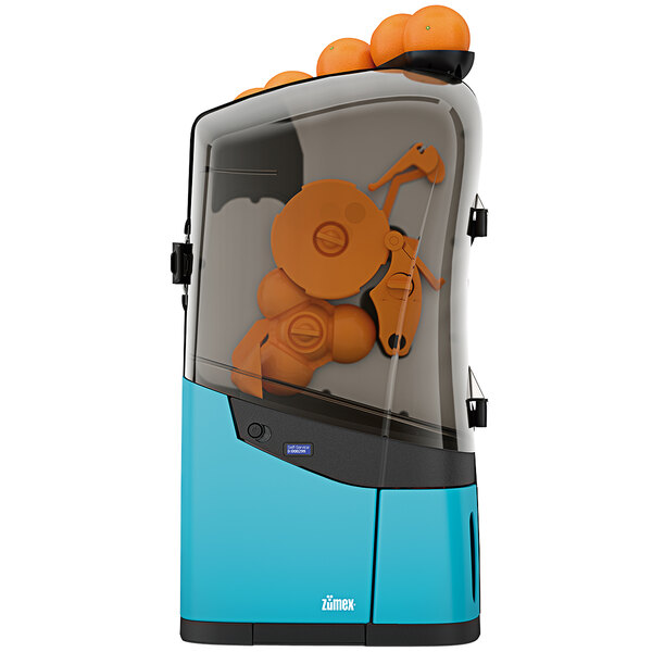 A blue Zumex Minex commercial orange juicer with oranges on top.
