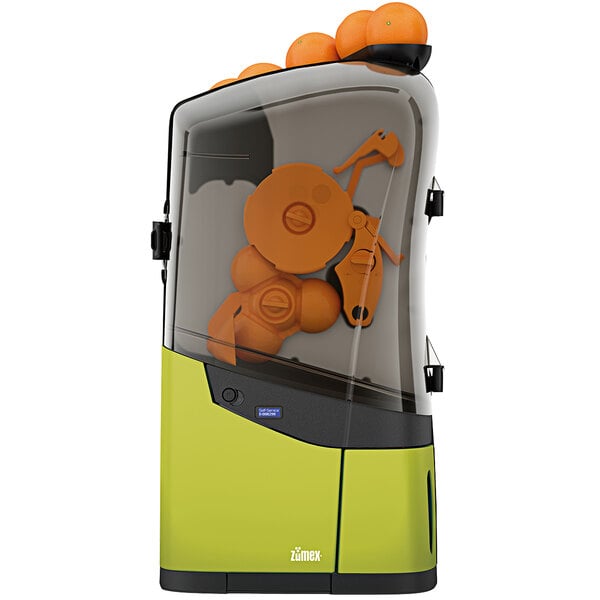 A green Zumex Minex commercial orange juicer with oranges inside.