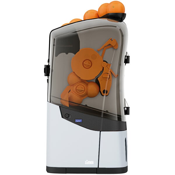 A Zumex Minex commercial orange juicer with oranges on top.