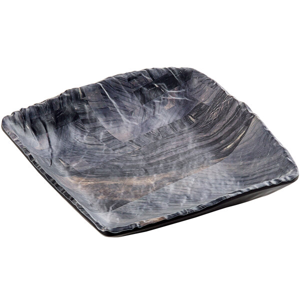A black square Tablecraft melamine tray with a wavy wood design.