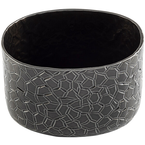 A black oval aluminum sugar packet holder with a crackle pattern.