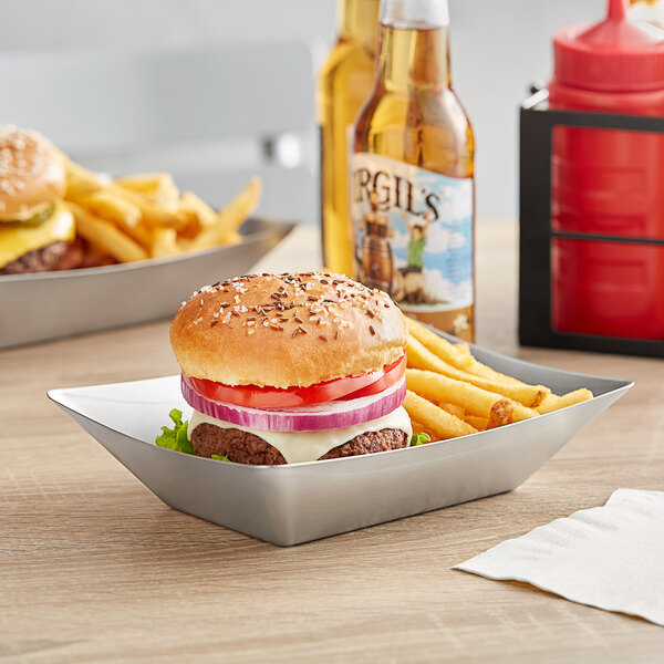 A Tablecraft stainless steel rectangular serving basket with a burger and fries.