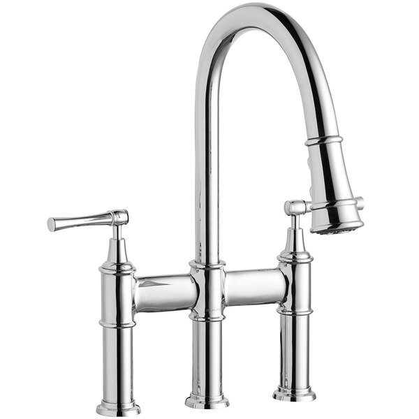 A silver Elkay deck-mount bridge faucet with lever handles and a sprayer.