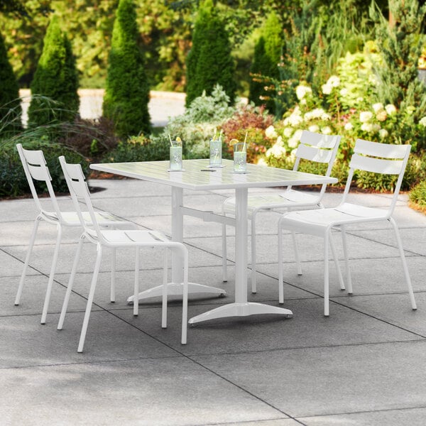 A white table and chairs on an outdoor patio.