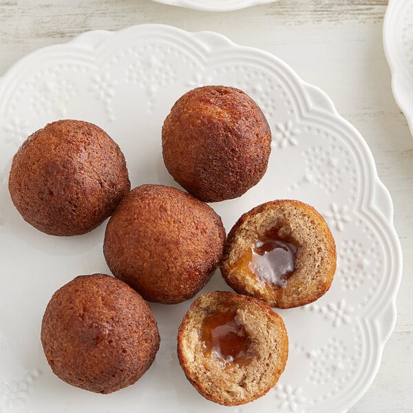 A plate of Rich's Ready-to-Finish Jumbo French Toast Filled Donut Bites on a table.