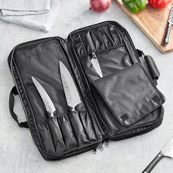 A black Kai knife case with knives inside.