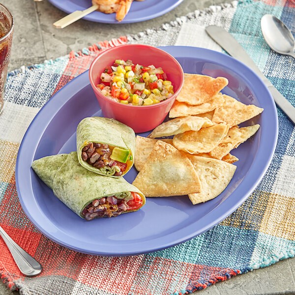 An Acopa purple melamine oval platter with tortillas, salsa, and chips on a table.